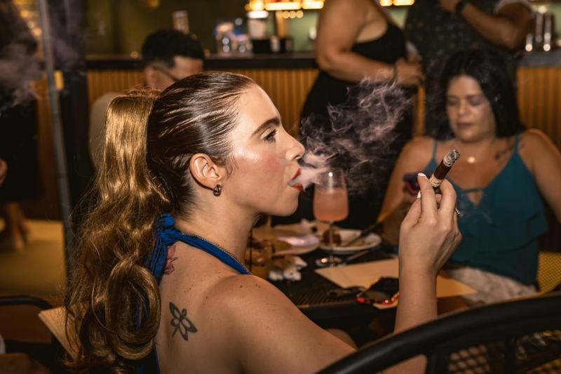 Asistente disfrutando un puro en la primera edición de Humo y Tambor